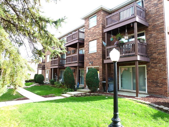 Front view of a multi-story residential building with balconies.