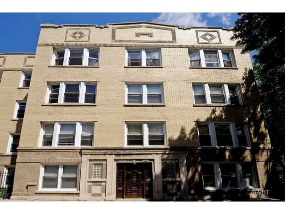 Front view of a multi-story brick apartment building