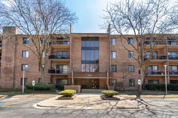 Front view of a multi-story brick apartment building.