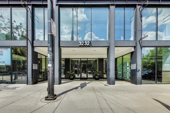 Front view of a modern glass-fronted building entrance.