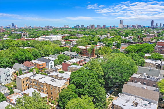 Wide-angle view of urban residential area with various buildings and extensive greenery.