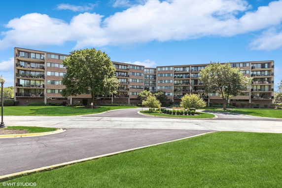 Front view of a multi-story residential building with balconies.