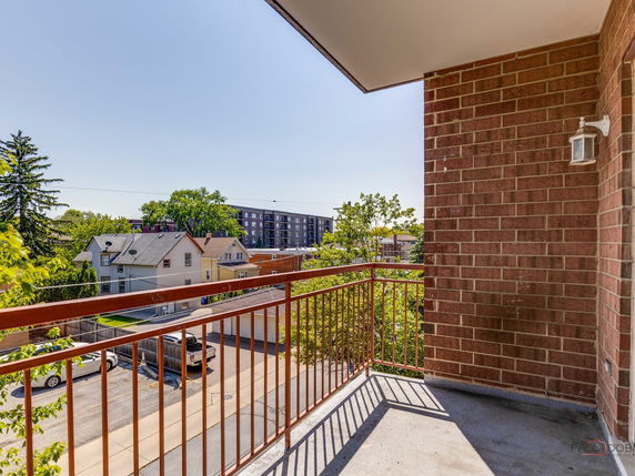 View from a balcony overlooking residential and apartment buildings.