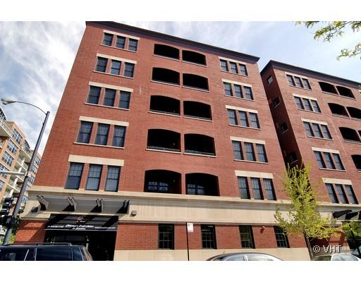 Front view of a multi-story brick building with multiple windows and balconies.