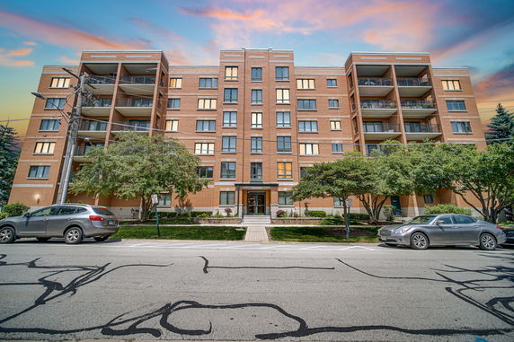 Front view of a multi-story building with balconies.
