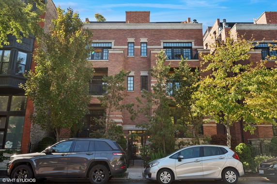 Front view of a multi-story brick building with balconies.