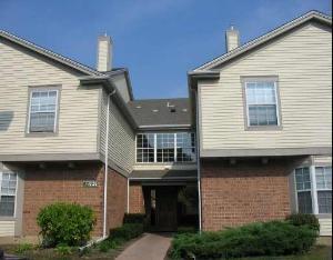 Front view of a two-story house with brick and siding exterior.