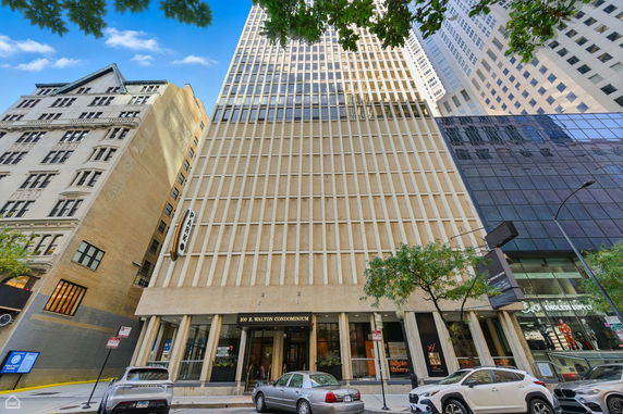 Front view of a tall commercial building with a modern facade and large glass windows.