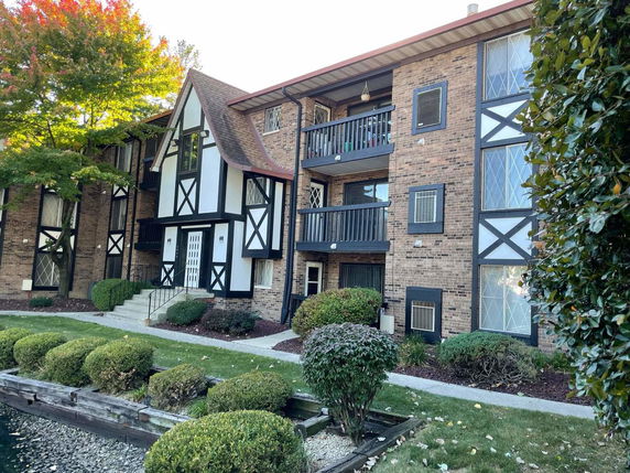 Front view of a multi-story building with brick and half-timbered exterior.