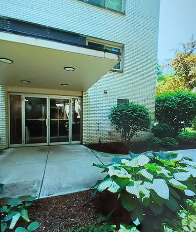 Front view of a building with a glass entrance door and canopy.