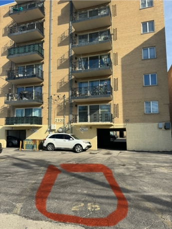 Front view of a multi-story apartment building with balconies.