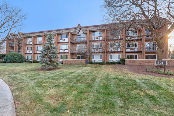 Front view of a multi-story brick building with balconies.