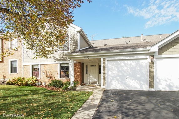 Front view of a two-story house with an attached garage.