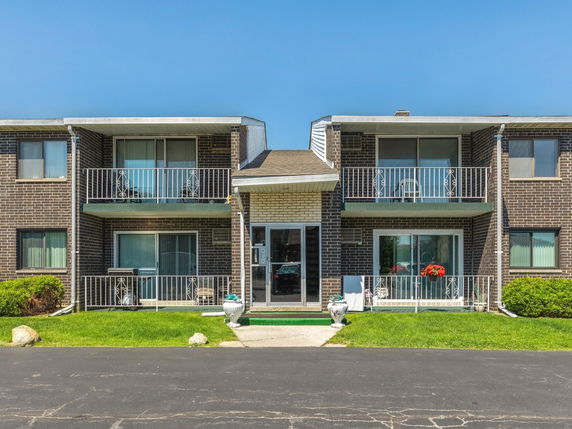 Front view of a multi-story building with balconies.
