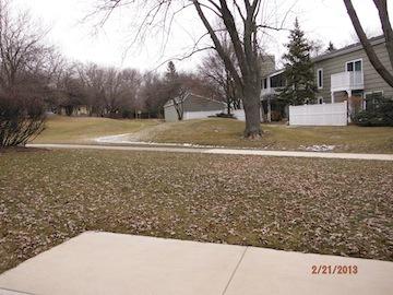 View of surrounding residential area with houses and trees.