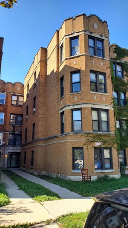 Front view of a multi-story brick residential building.