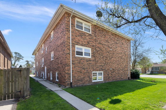 Side view of a three-story brick building.