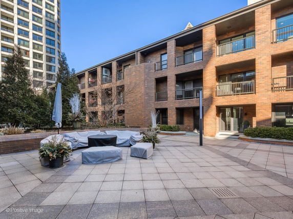 Exterior view of a multi-story brick apartment building.