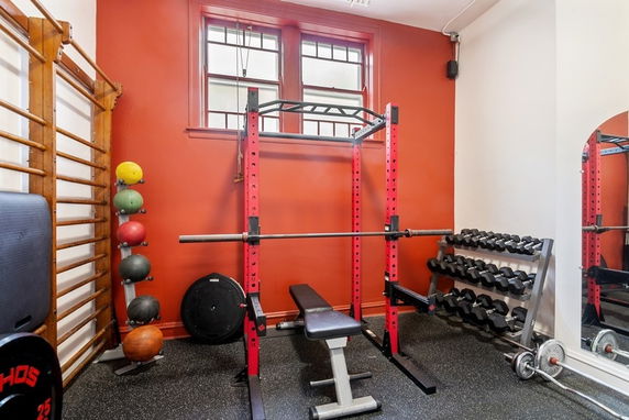 Indoor gym area with weightlifting equipment.