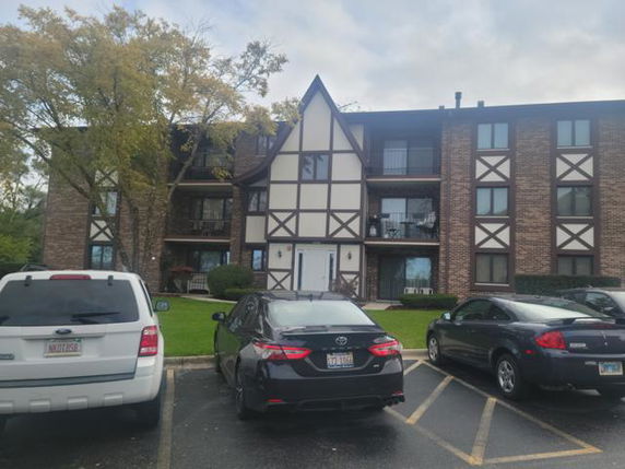 Front view of a multi-story building with Tudor-style architecture.