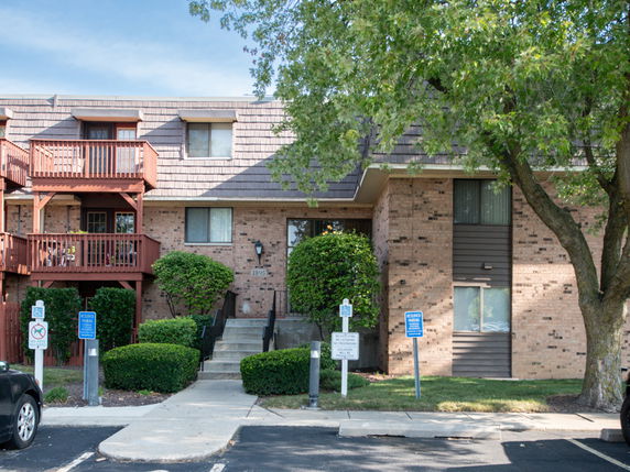 Front view of a multi-story residential building with balconies.