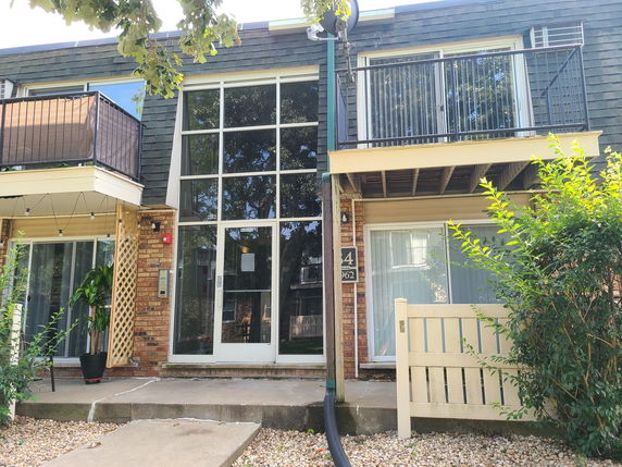 Front view of a two-story building with large windows and balconies.