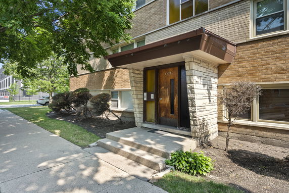 Front view of a building with a brick and stone entrance.