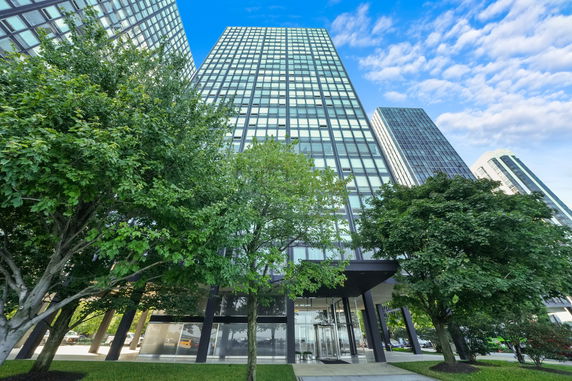 Front view of a modern high-rise building with glass facade.
