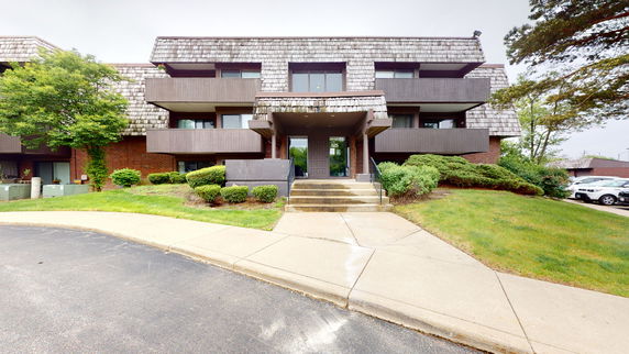 Front view of a multi-story residential building with balconies.