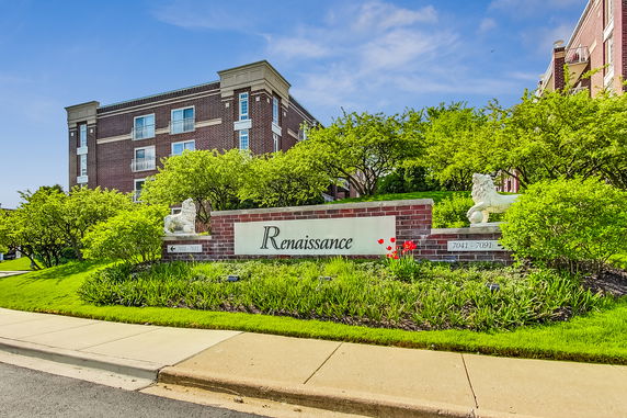 Front view of a brick residential building with a prominent entry sign labeled Renaissance.