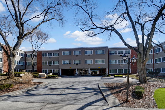 Front view of a multi-story residential building with a central entrance.
