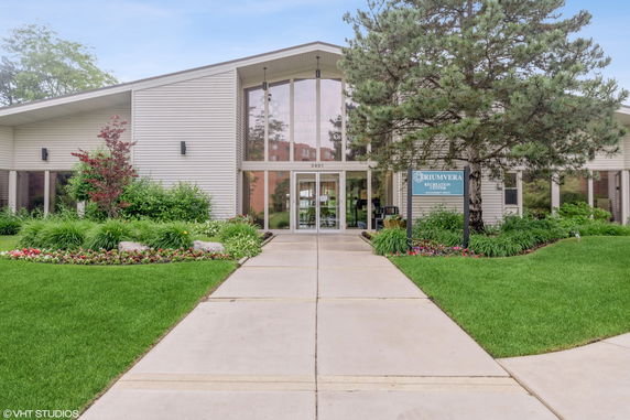 Front view of a modern building with large glass entrance.