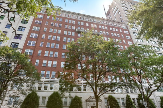 Front view of a multi-story brick building with numerous windows.