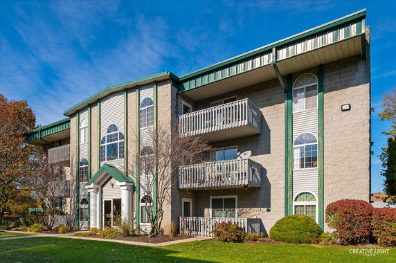Front view of a multi-story residential building with balconies.