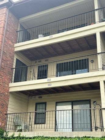 Front view of a multi-story building with multiple balconies.