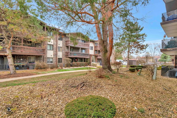 Front view of a multi-story residential building with balconies.