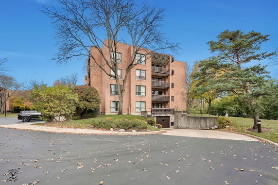 Front view of a multi-story brick apartment building.
