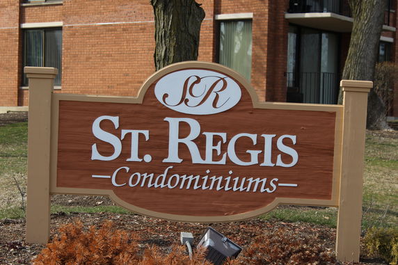 Front view of a condominium building with a St. Regis sign.