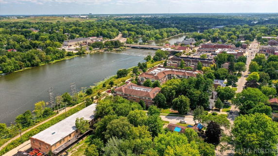 Panoramic view of a river surrounded by a town and green landscape.