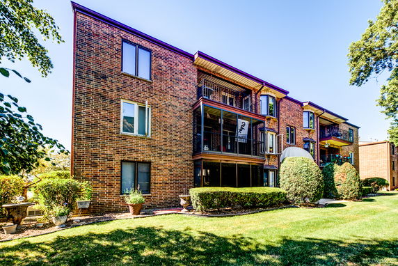 Front view of a multi-story brick apartment building.