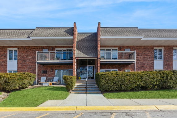 Front view of a two-story brick building with balconies.