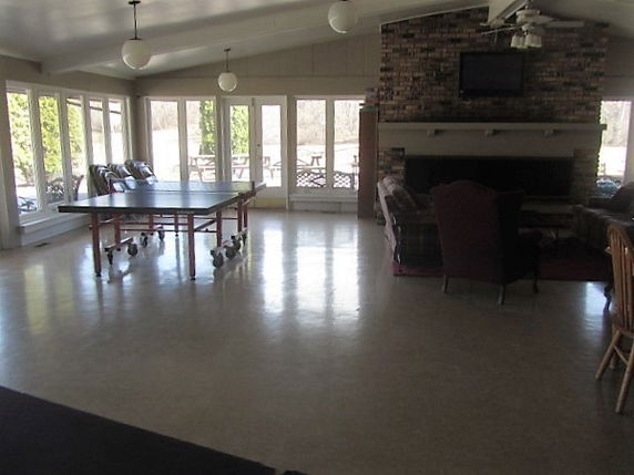 Indoor recreational area with ping pong table and seating.