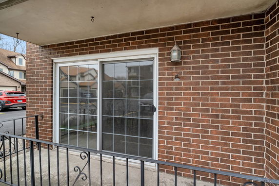 Exterior view of a building with brick walls and sliding glass doors.