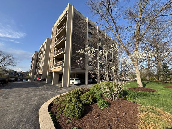 Front view of a multi-story residential building with balconies.