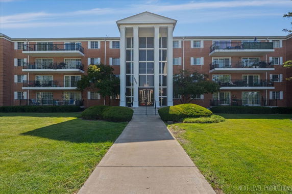 Front view of a multi-story building with balconies.