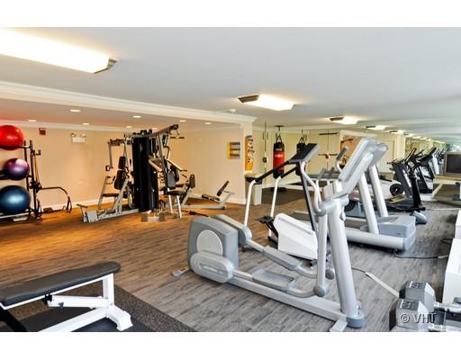 Room equipped with gym machines including treadmills and exercise equipment.