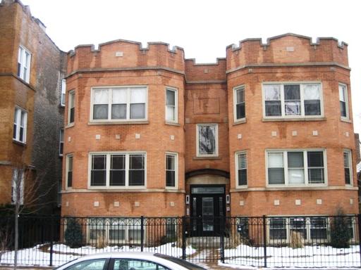 Front view of a brick building with two prominent rounded sections.