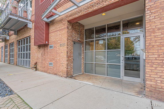 Front view of a building with brick exterior and large glass entryway.