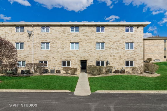 Front view of a three-story brick apartment building.