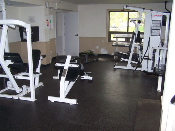 Indoor gym area with exercise equipment.